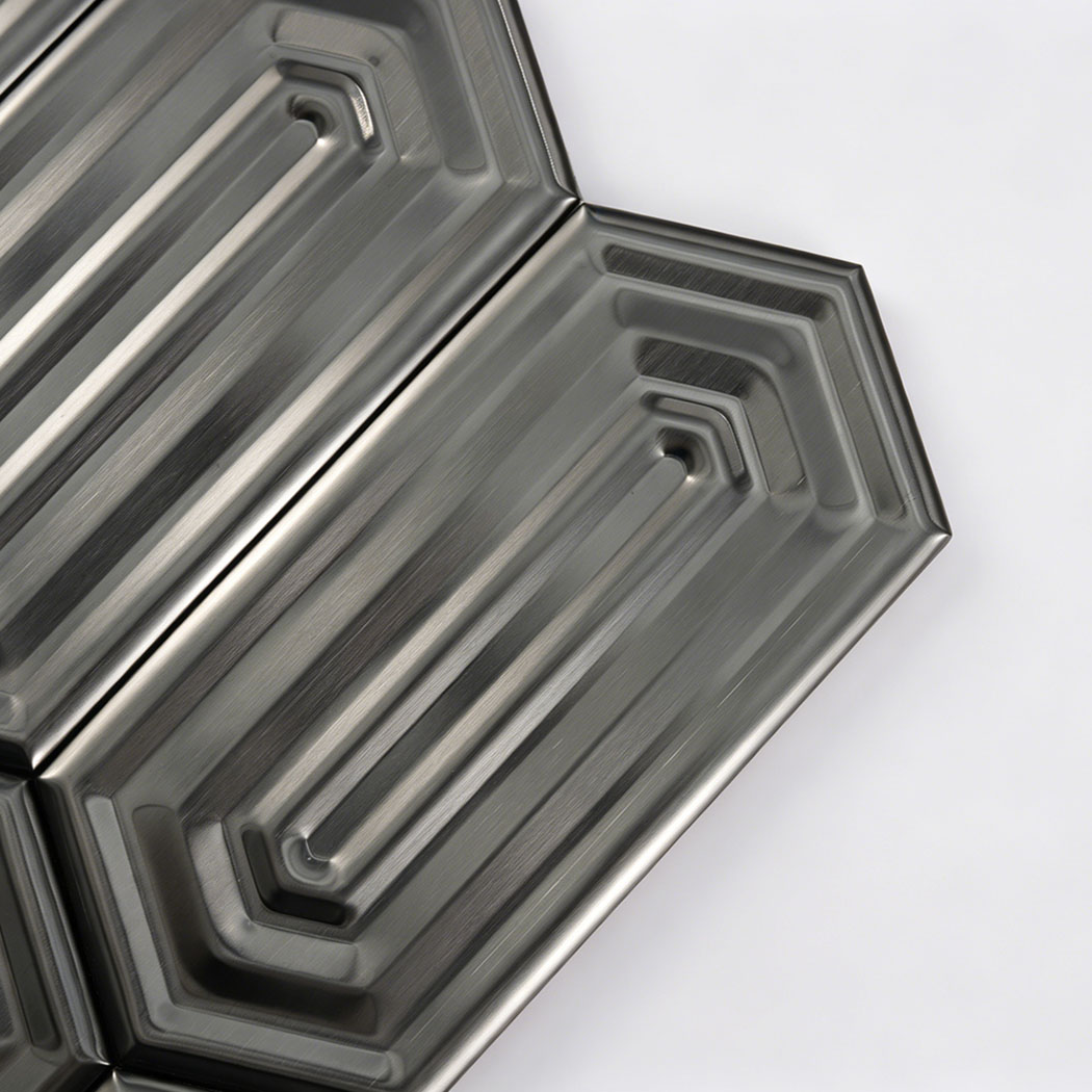 Brushed stainless steel picket mosaic tile close up showing layered stepped geometric grooves