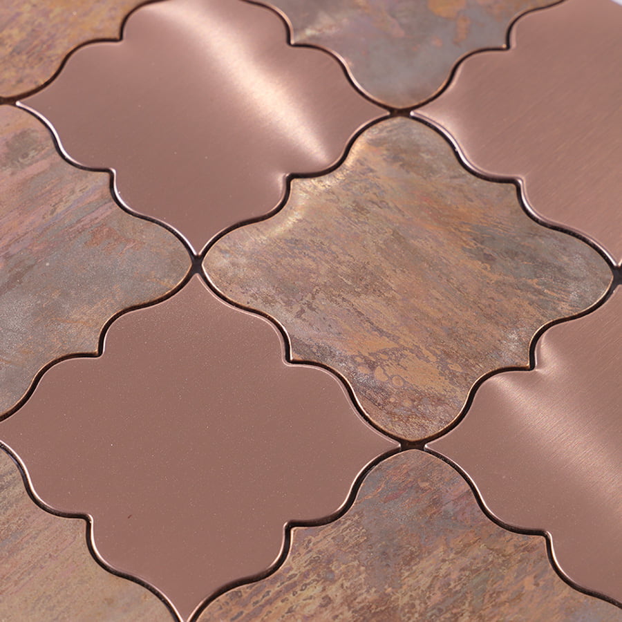 Texture detail of brushed rose gold and antique bronze arabesque mosaic tile