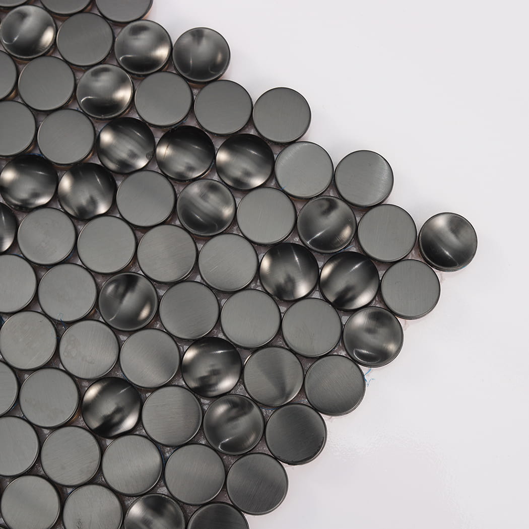 Close-up of black brushed mixed profile concave flat and convex stainless steel penny rounds.