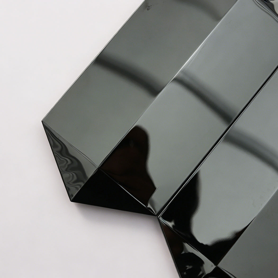 Close up of black mirror picket mosaic tile edge with beveled glossy ends
