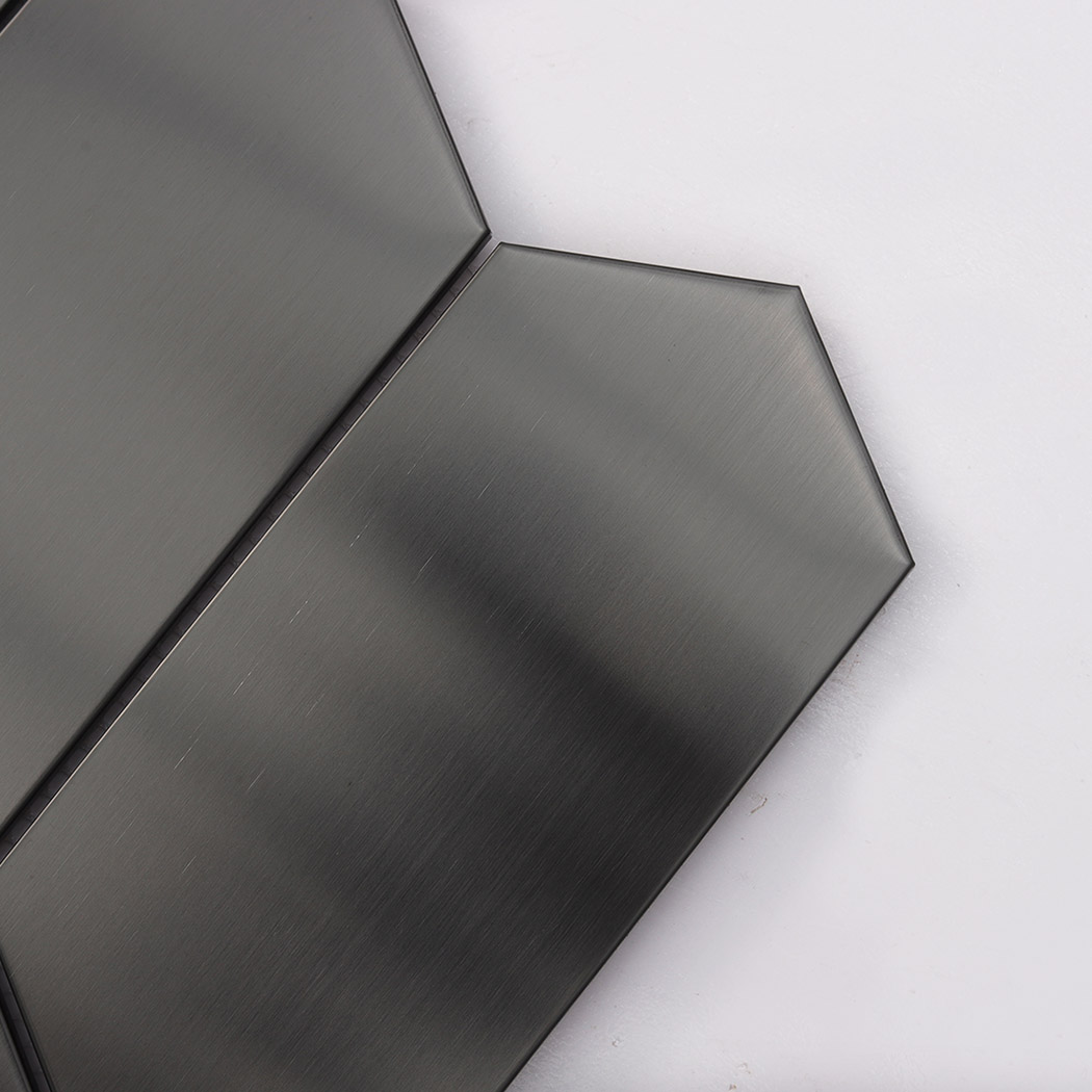 Close up brushed black hexagon metal tile showing fine brushed grain texture