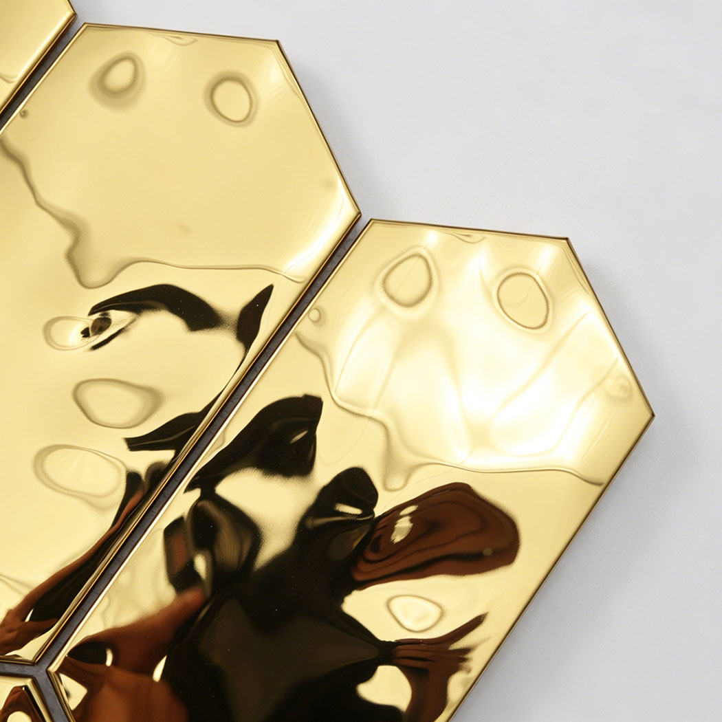 Close up glossy gold hexagon tile showing reflective metallic surface detail