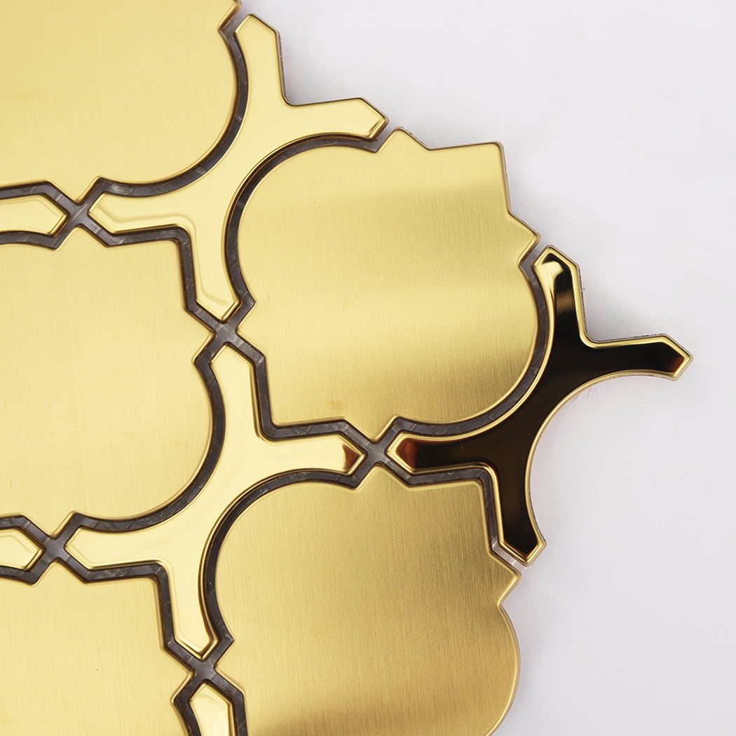 Close-up detail of a brushed gold lantern mosaic tile with reflective edges.