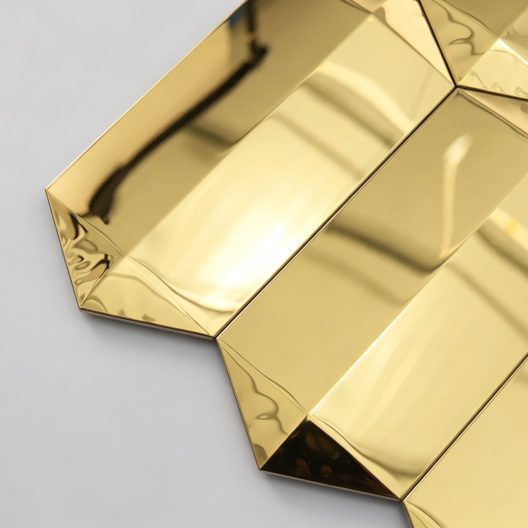 Close up of gold mirror picket mosaic tile edge with beveled reflective ends