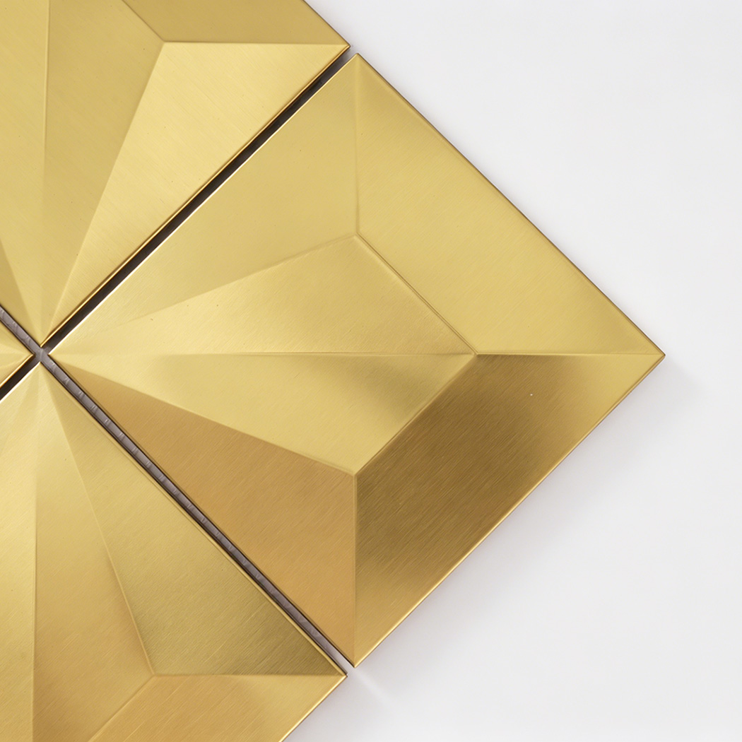 Close up of gold pyramid square mosaic tile with brushed metal texture