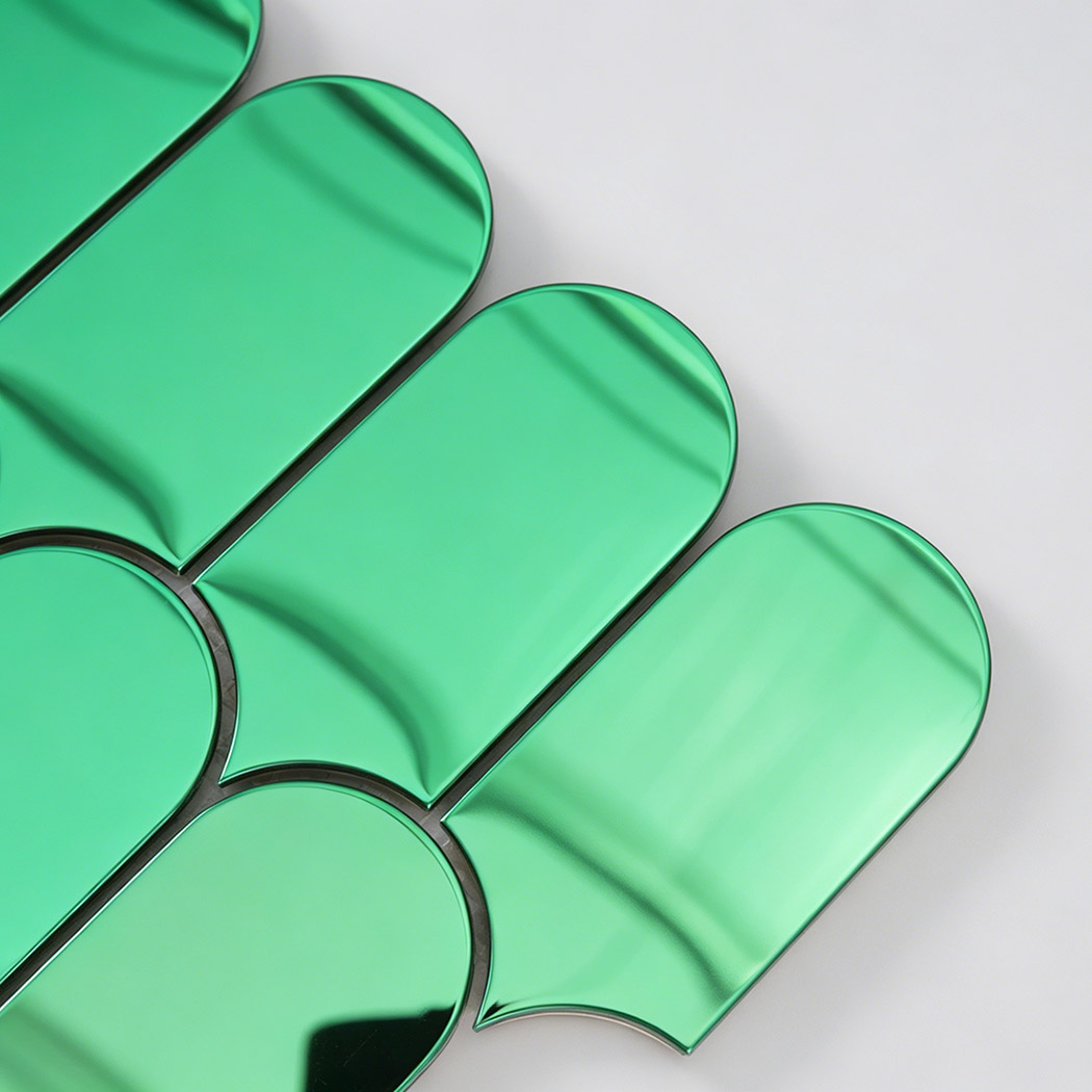Close up of green arch metal mosaic tile edge with rounded shape and reflection