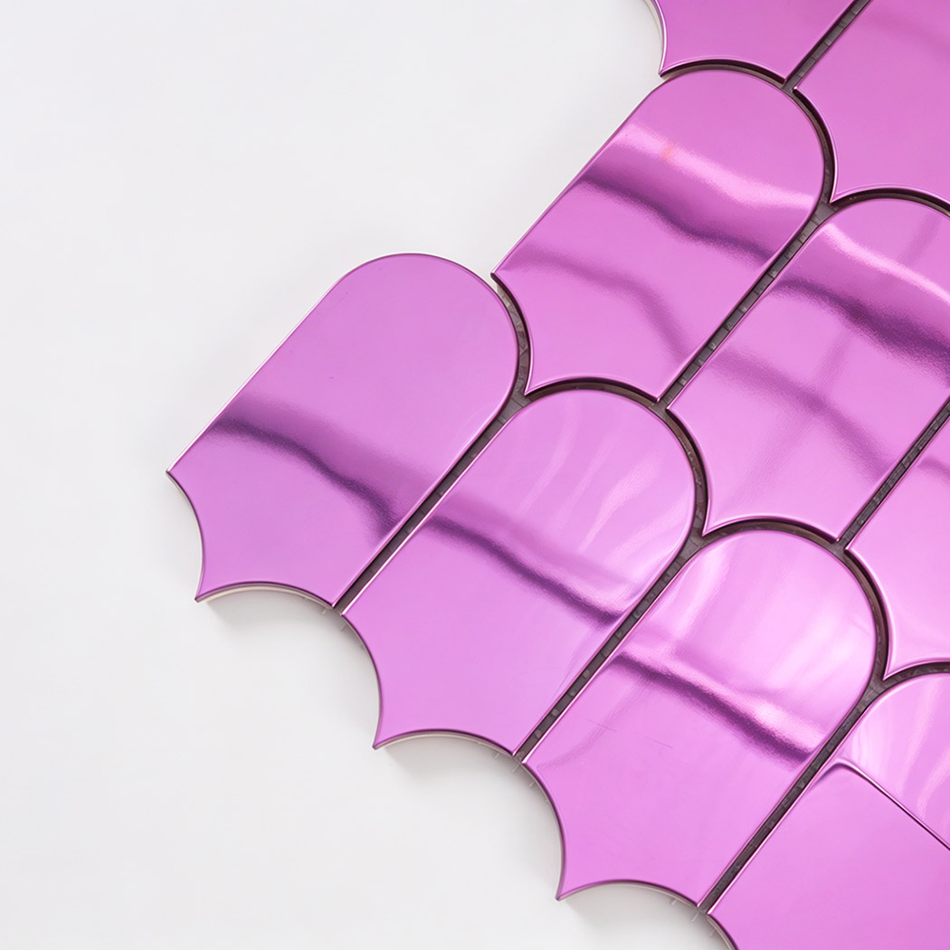 Close up of pink arch metal mosaic tile edge with rounded shape and shine