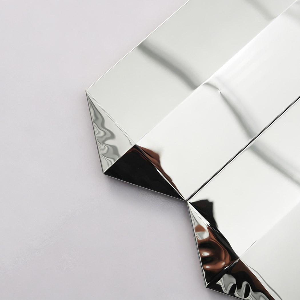 Close up of silver mirror picket mosaic tile edge with reflective beveled ends