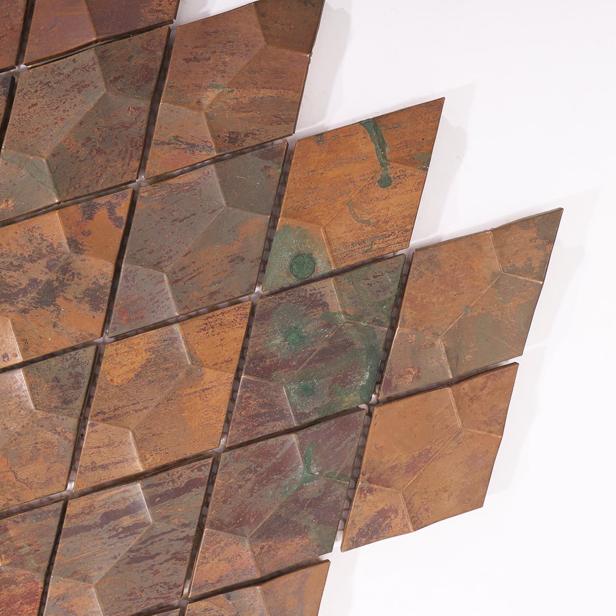 Close-up showing the aged copper finish and raised diamond texture