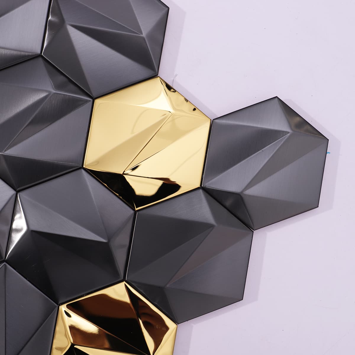 Detail of black and gold faceted tiles with metallic texture