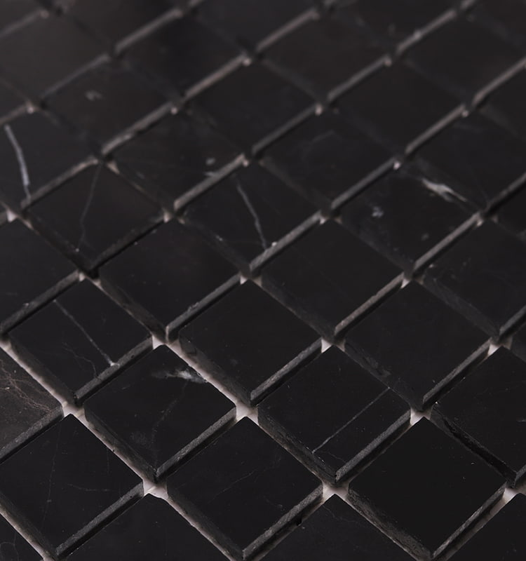 Close-up of Nero Marquina square mosaic tile with white veining and polished finish