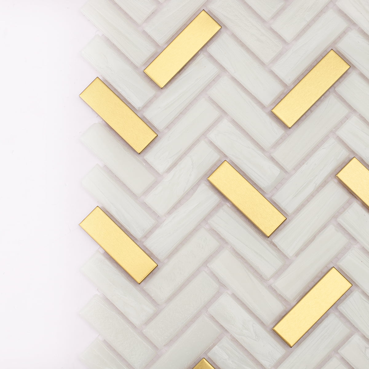 Close-up of glass and gold metal herringbone mosaic pattern