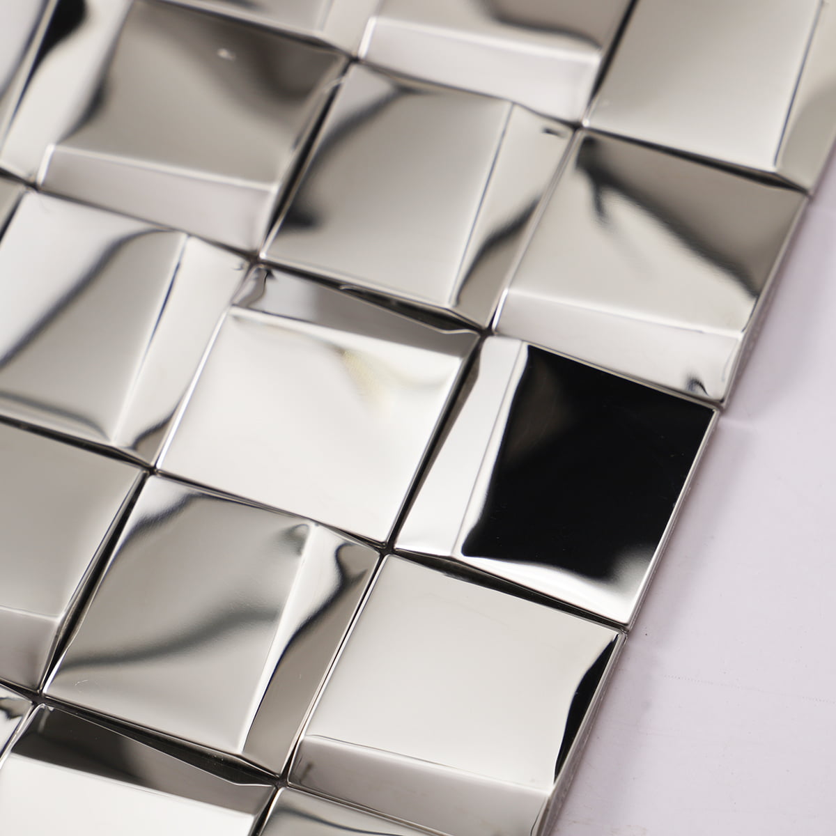 Close-up of reflective silver square tiles arranged in a modern pattern
