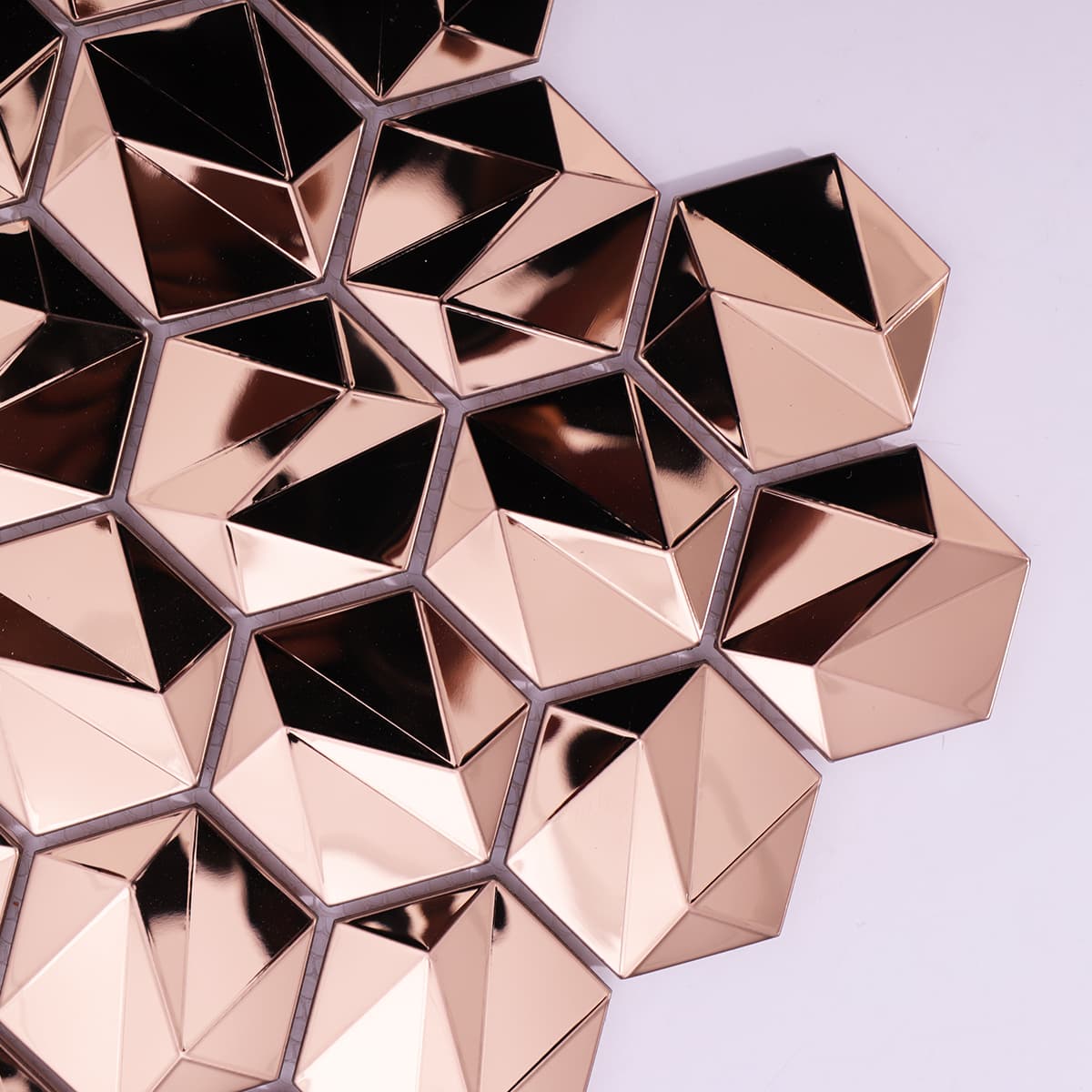 Glossy rose gold 3D hexagon mosaic tiles in close-up