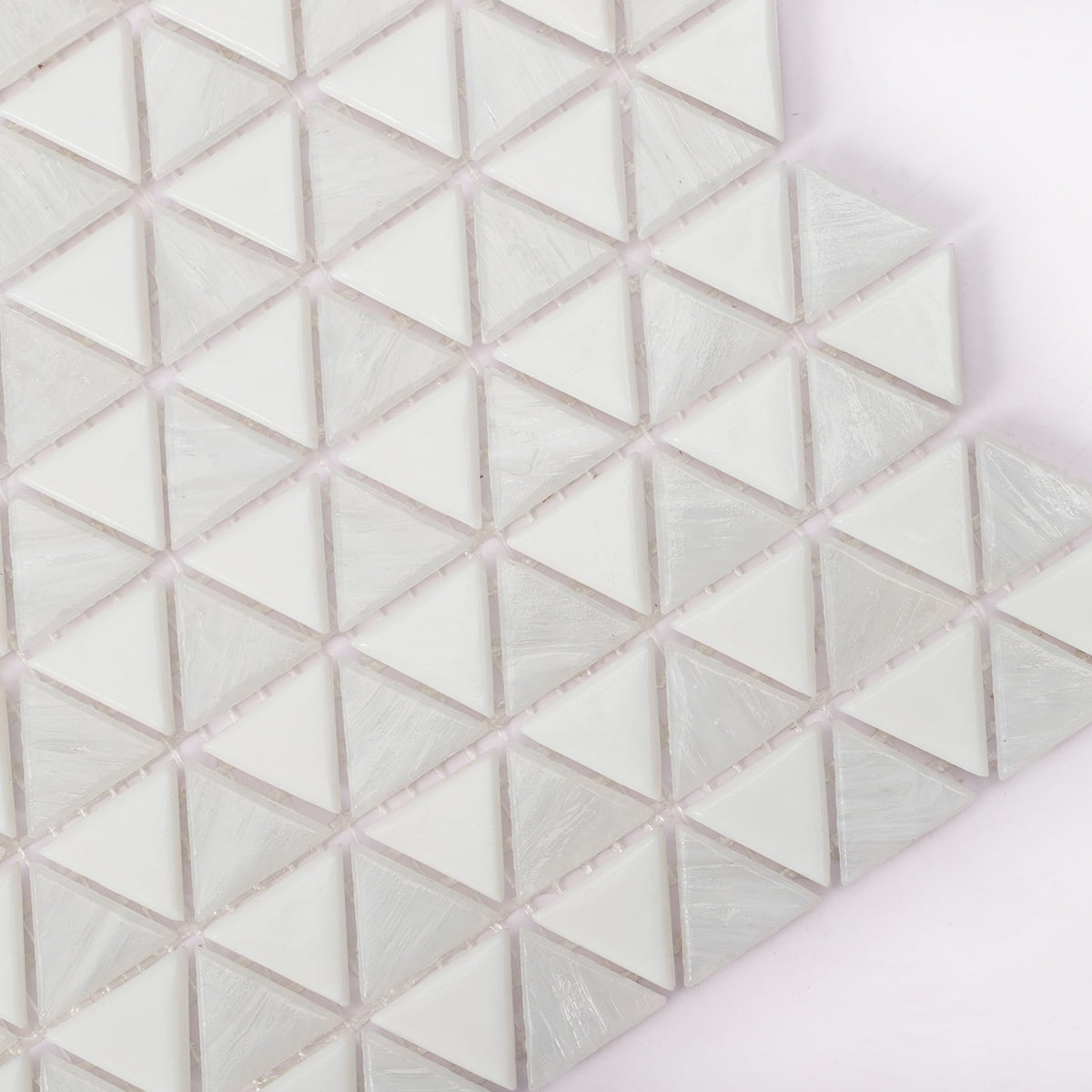 Close-up of white triangle mosaic tiles with a glossy finish and subtle texture