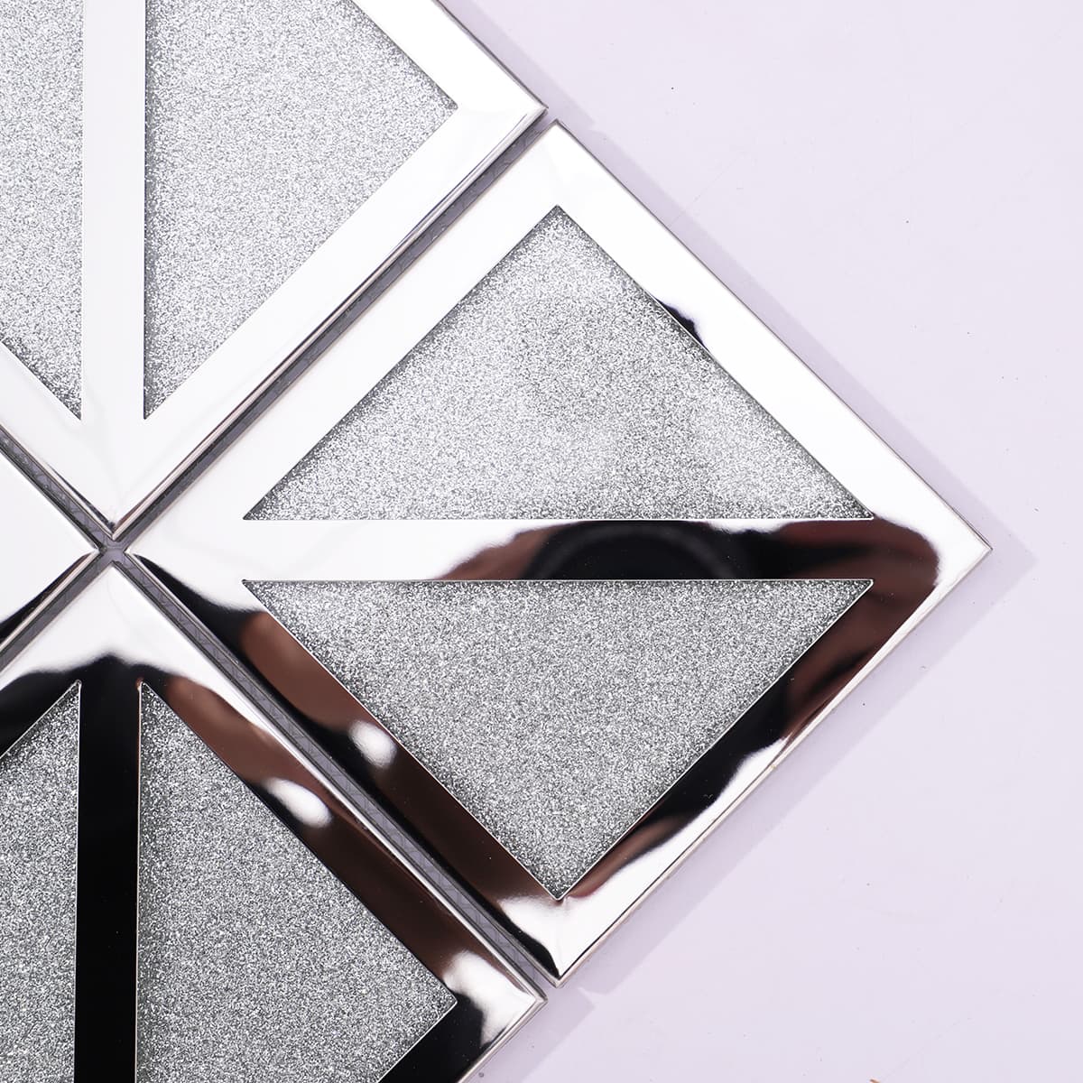 Close-up of glitter silver mosaic with mirror chrome V-frame
