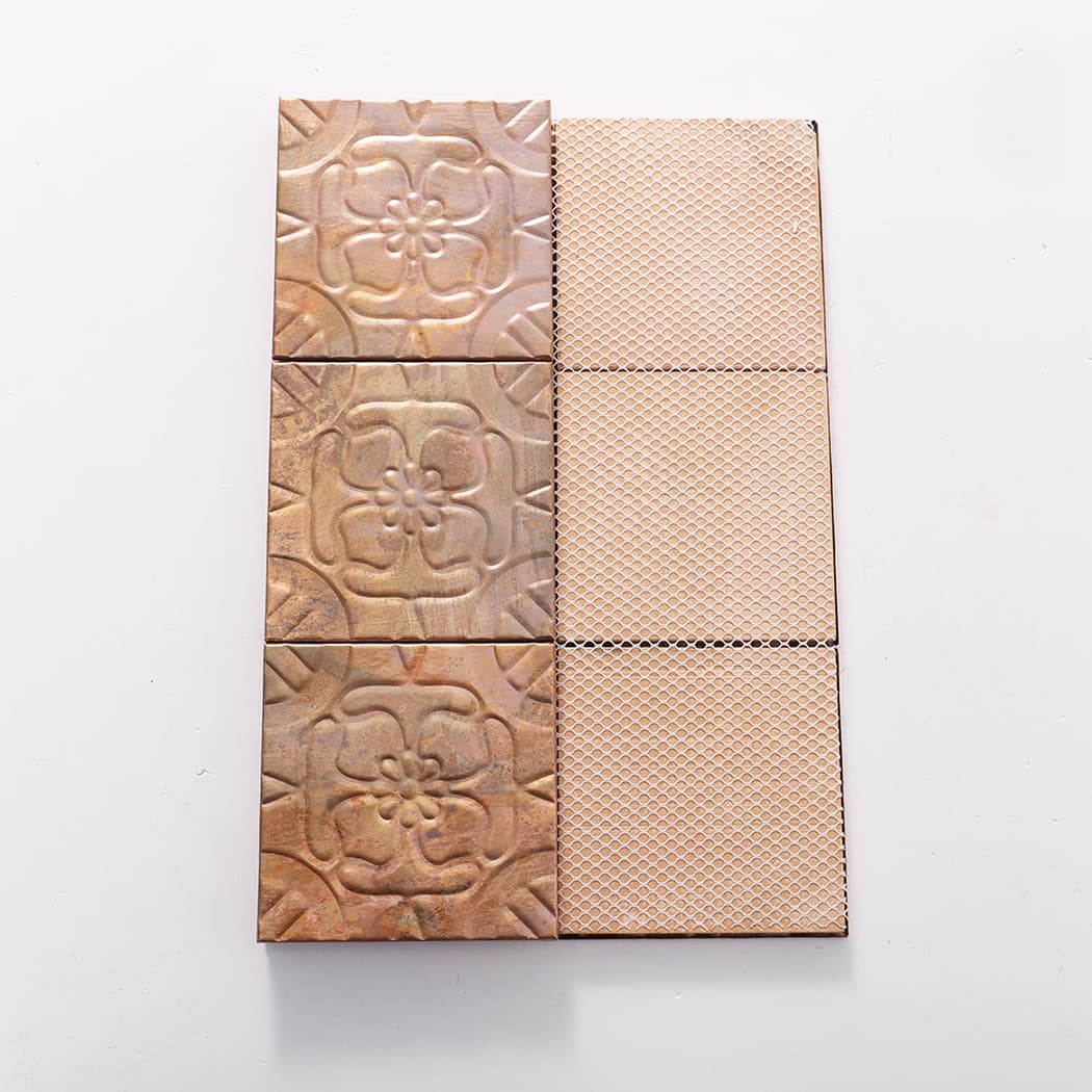 Front and back view of copper embossed flower mosaic tiles showing mesh backing for installation.