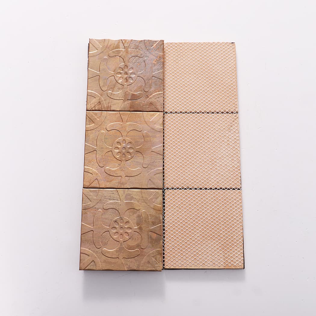 Front and back view of copper embossed mosaic tile sheet showing mesh backing.