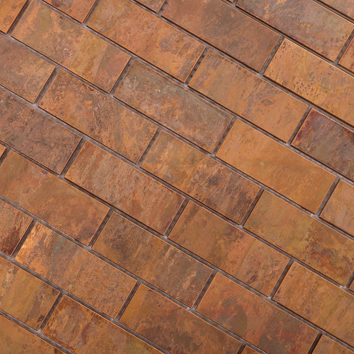 Angled view showing texture and colors of copper rectangle mosaic tiles