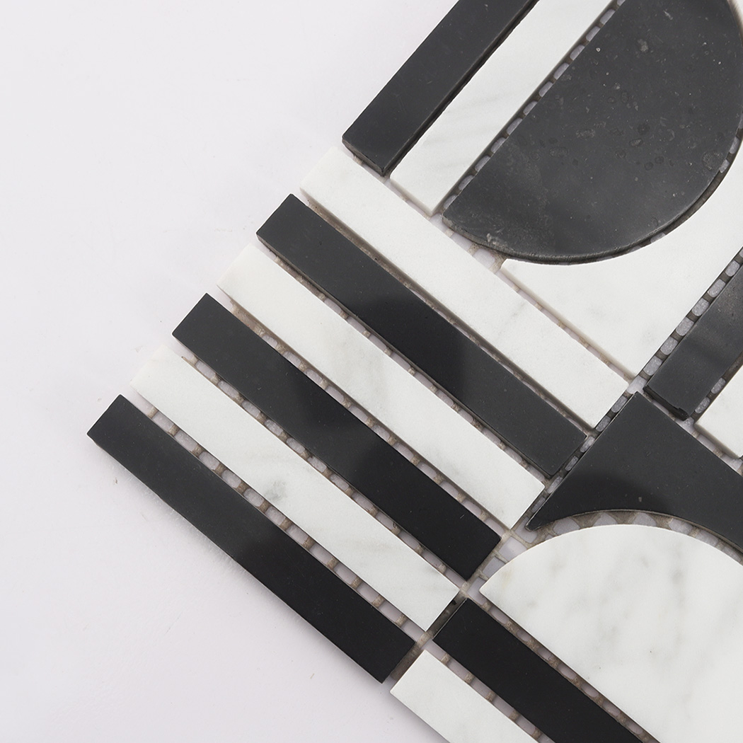 Angled close up of black and white marble mosaic tile showing geometric pattern.