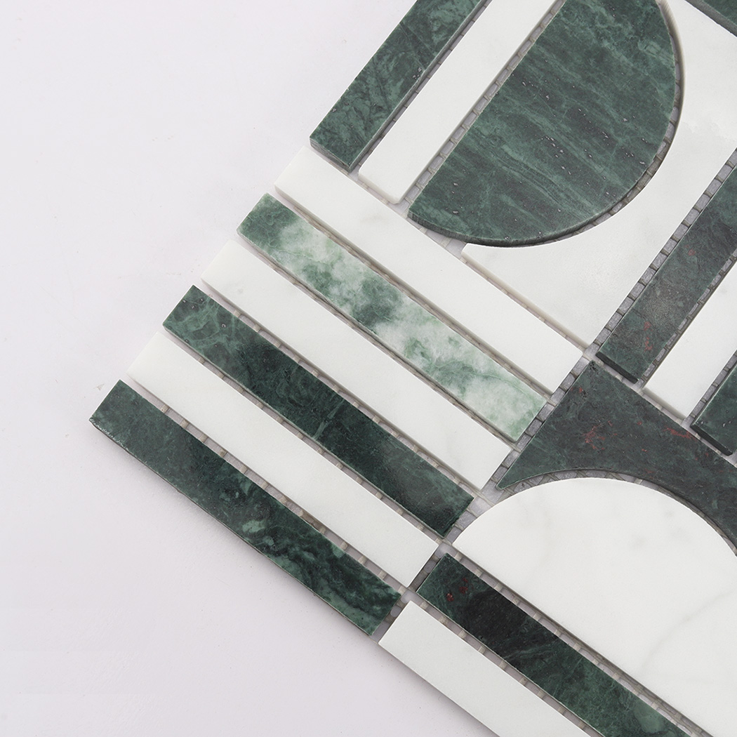Angled close-up of green and white marble mosaic tile showing geometric pattern.