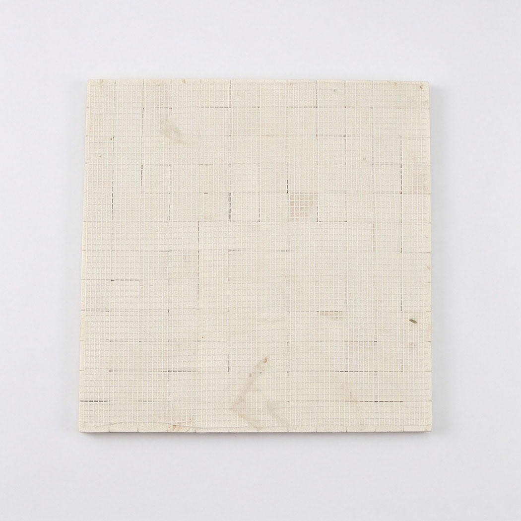 Mesh backing of cream 3D square mosaic tile sheet