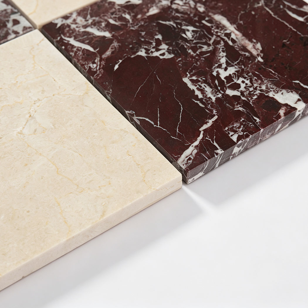 Edge detail of cream and burgundy marble checkered mosaic tile