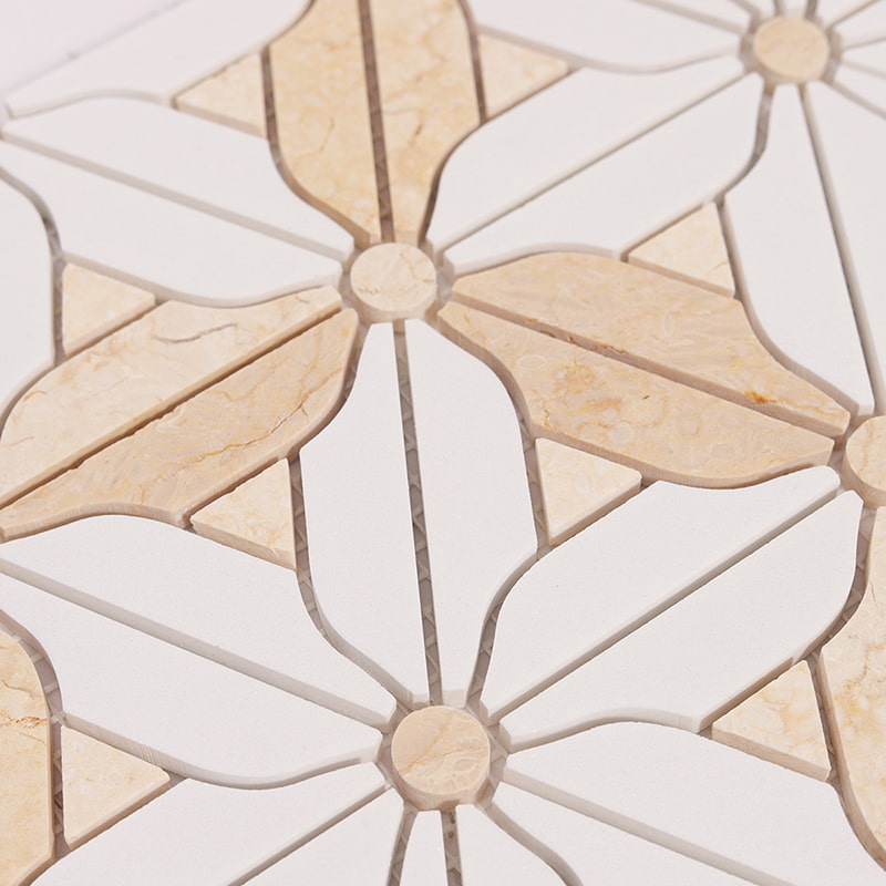 Crema Marfil and white marble mosaic tile with a geometric design.