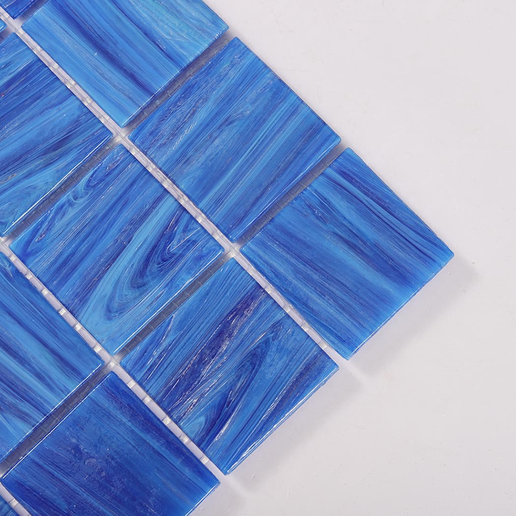 Close up of corner detail on dark blue glass mosaic tile sheet