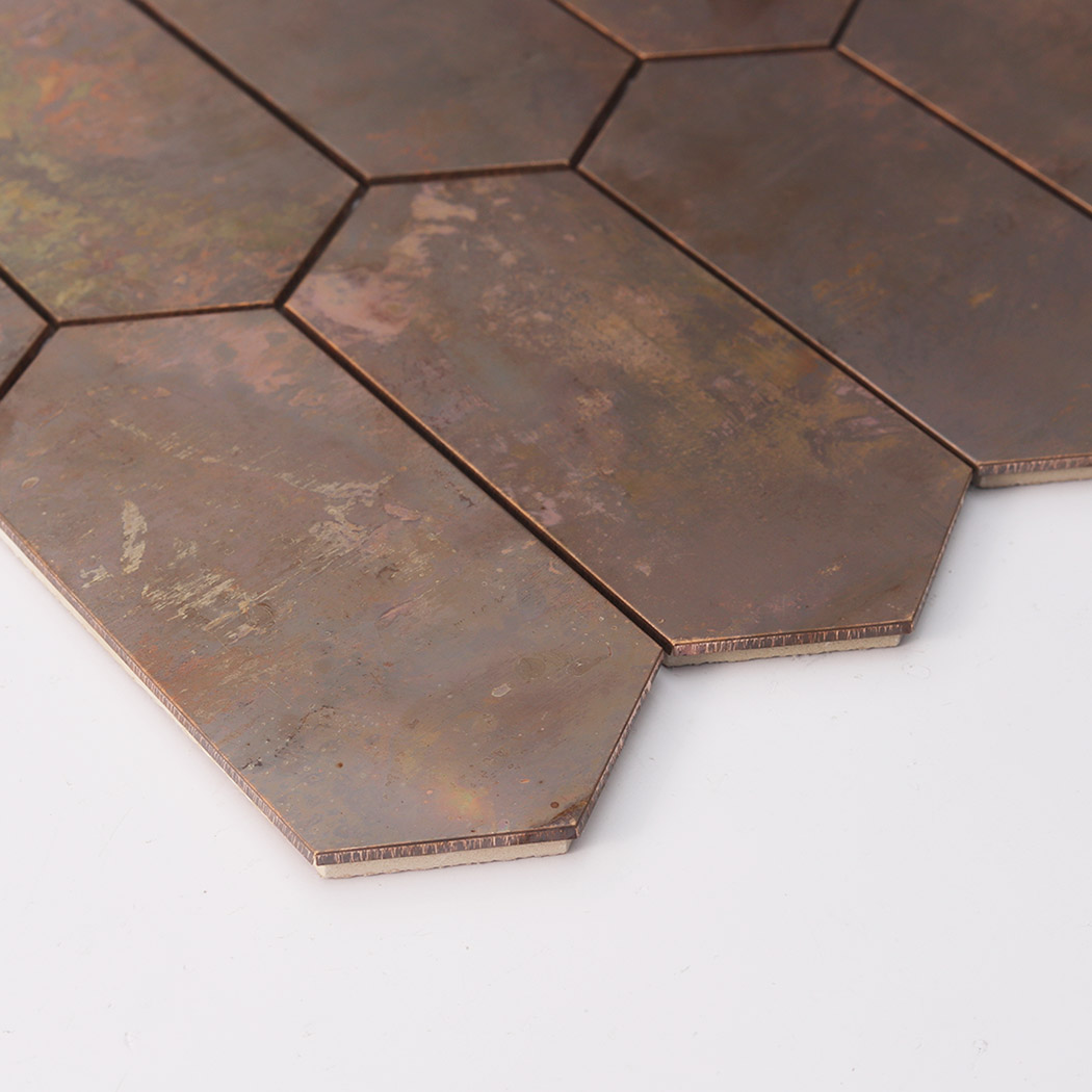 Angled view of dark oxidized copper hexagon mosaic tile with weathered metallic finish