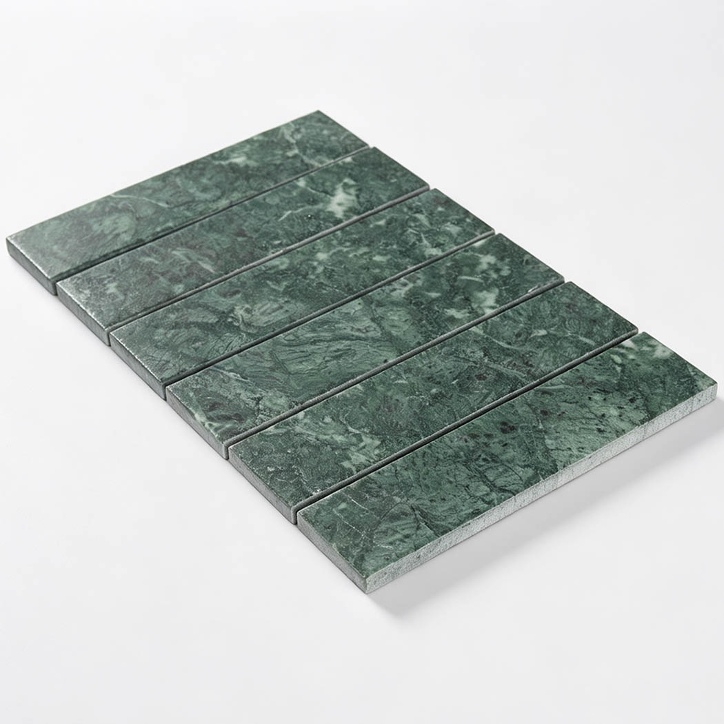 Angled view of a dark green marble strip tile sheet with six rectangular pieces