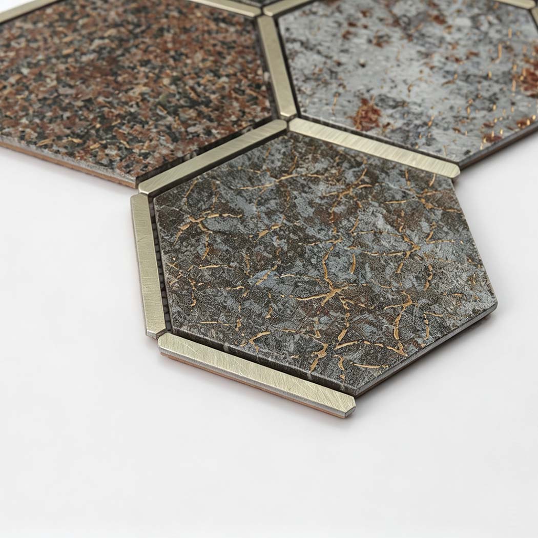 Angled close-up of dark grey aluminum hexagon mosaic tile with gold veining