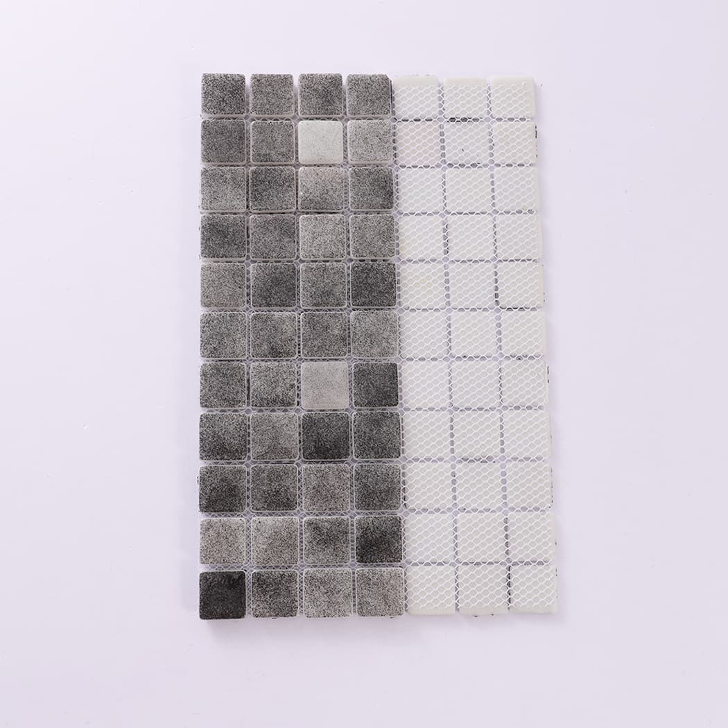 Backside view of dark grey recycled glass mosaic tile sheet with mesh backing