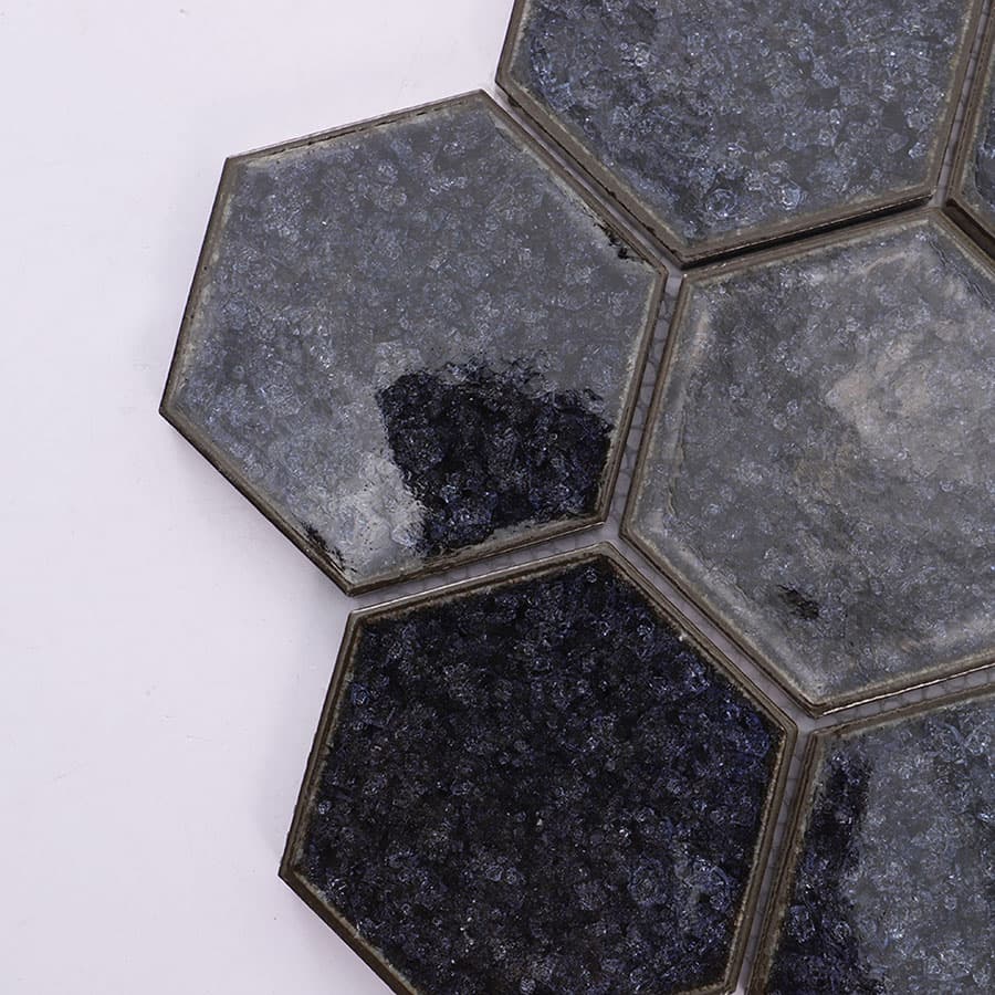 Corner close up of black crackle hexagon mosaic tile
