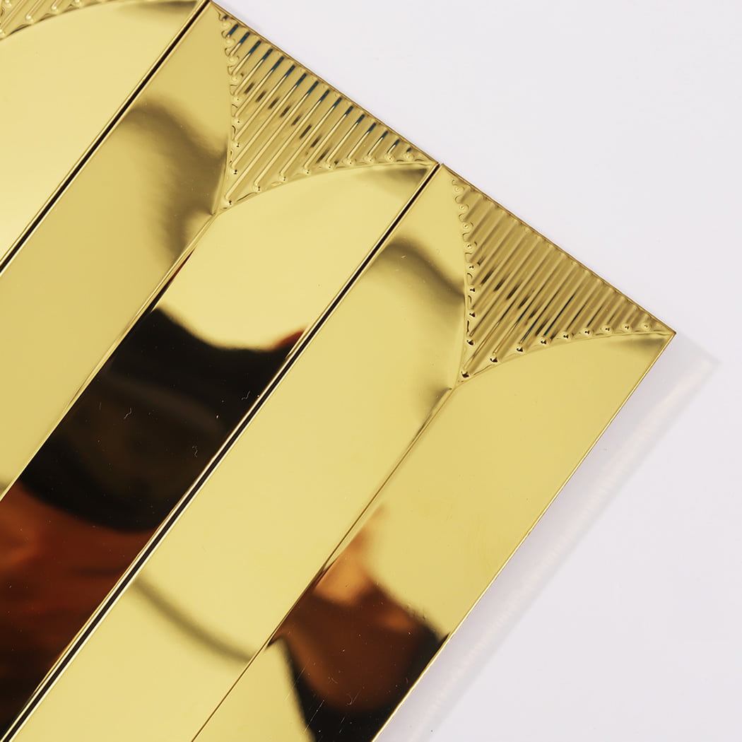 Close-up of the decorative textured triangular ends on gold metal mosaic tiles.