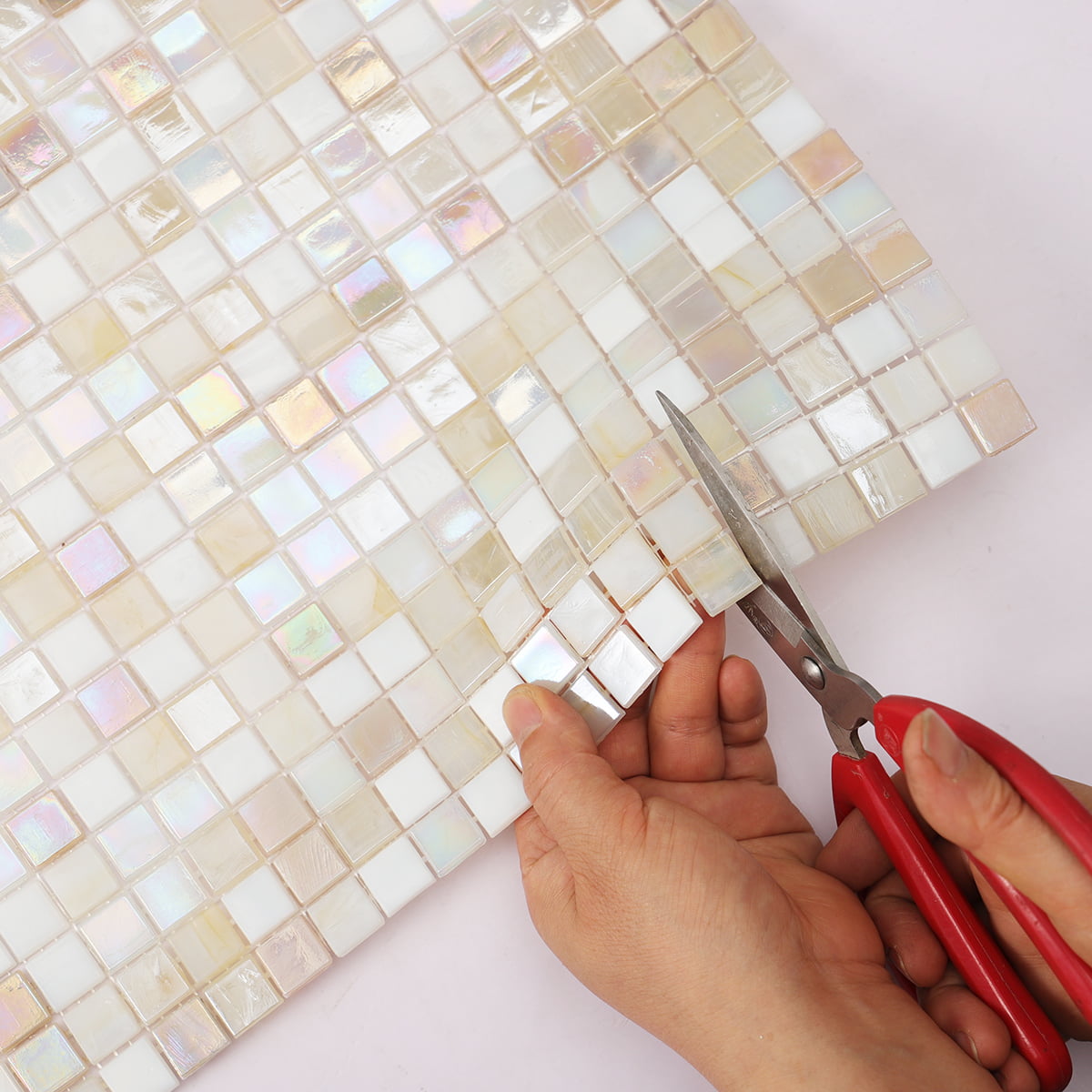 Detail of massage bed beside a mosaic tile feature wall