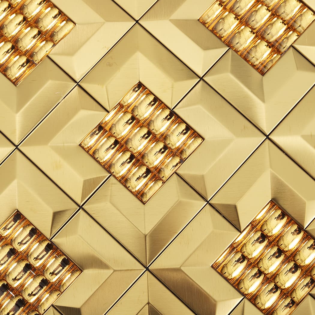 Macro detail of the textured center and smooth beveled frames of gold 3D mirror tiles.