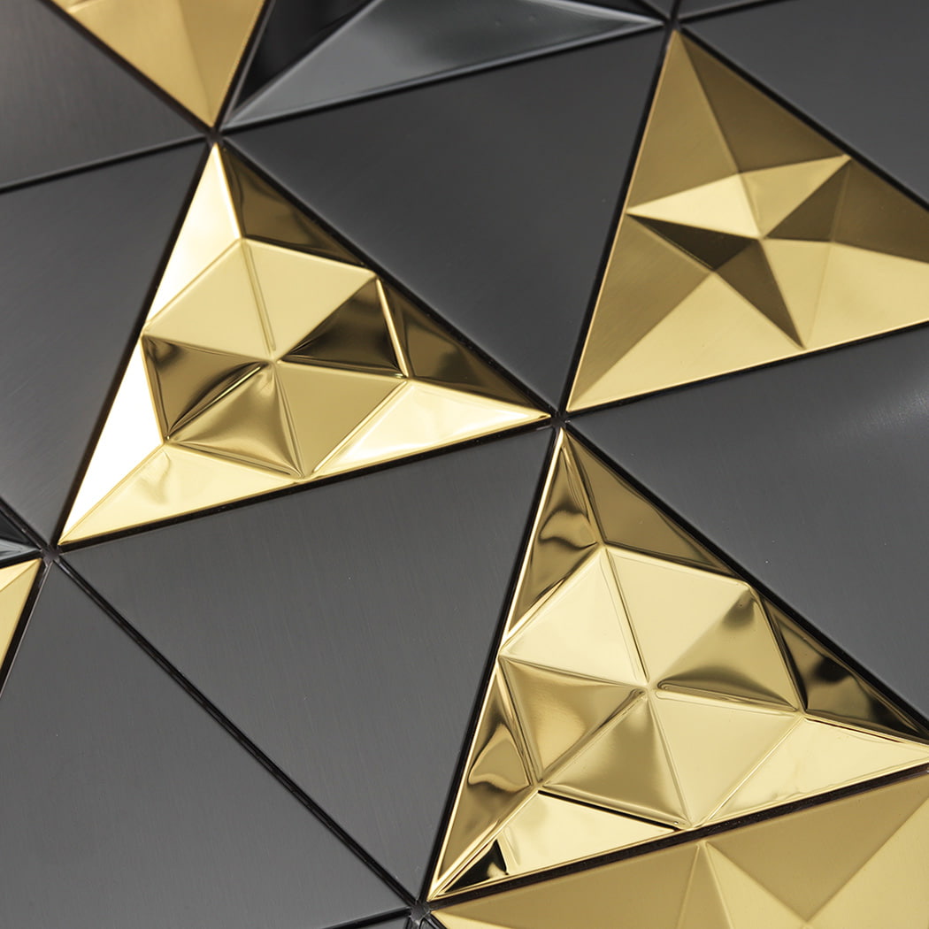 Detailed view of faceted 3D metal triangle mosaic tiles reflecting light.