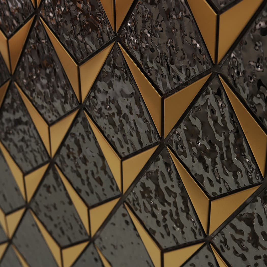 A focused shot on a wall covered in black and gold diamond mosaic tiles, emphasizing texture and reflections.