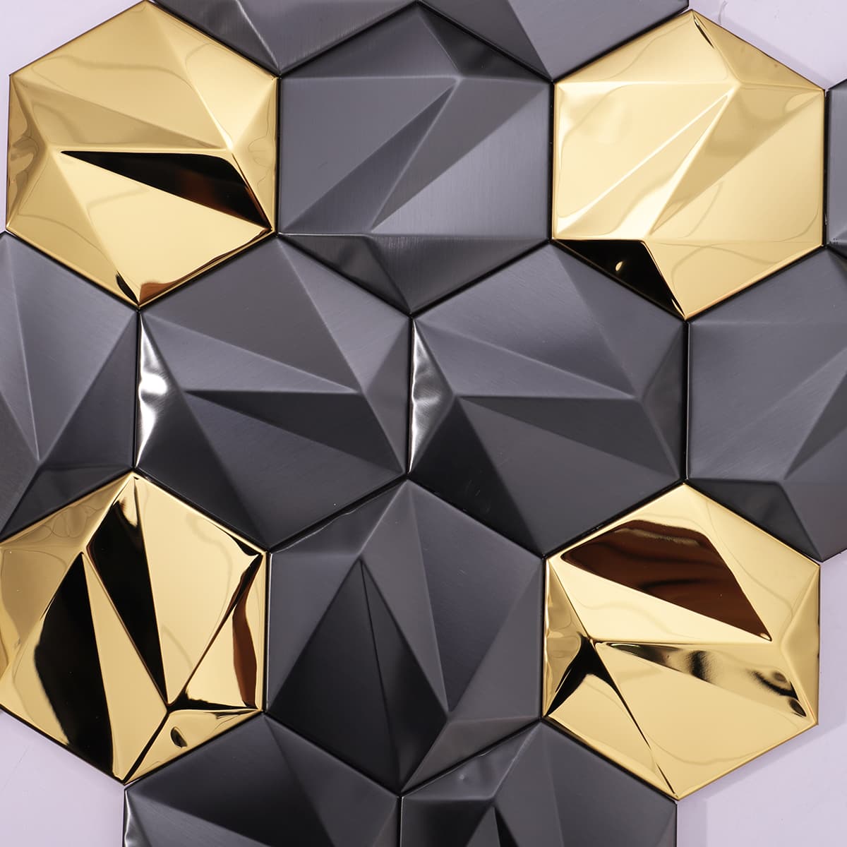 Diamond-cut 3D mosaic tiles in matte black and mirror gold finish.