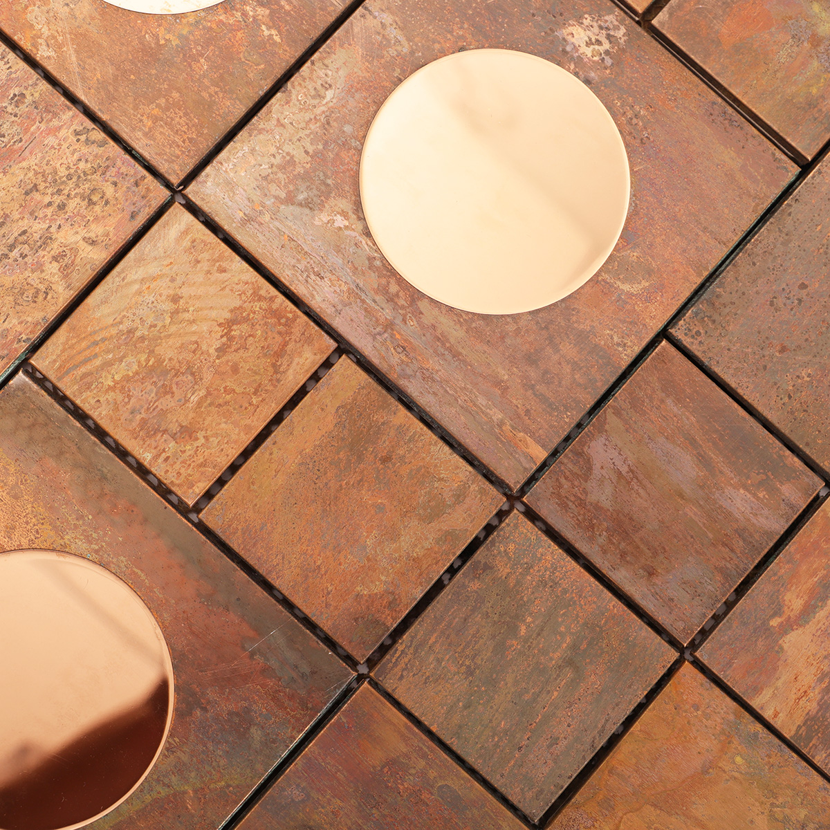 Close-up showing the aged copper texture and brushed stainless steel contrast
