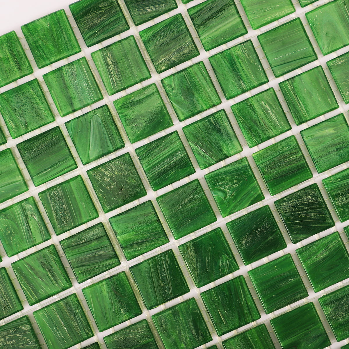 Detailed shot of glossy green mosaic tiles with subtle variations in texture