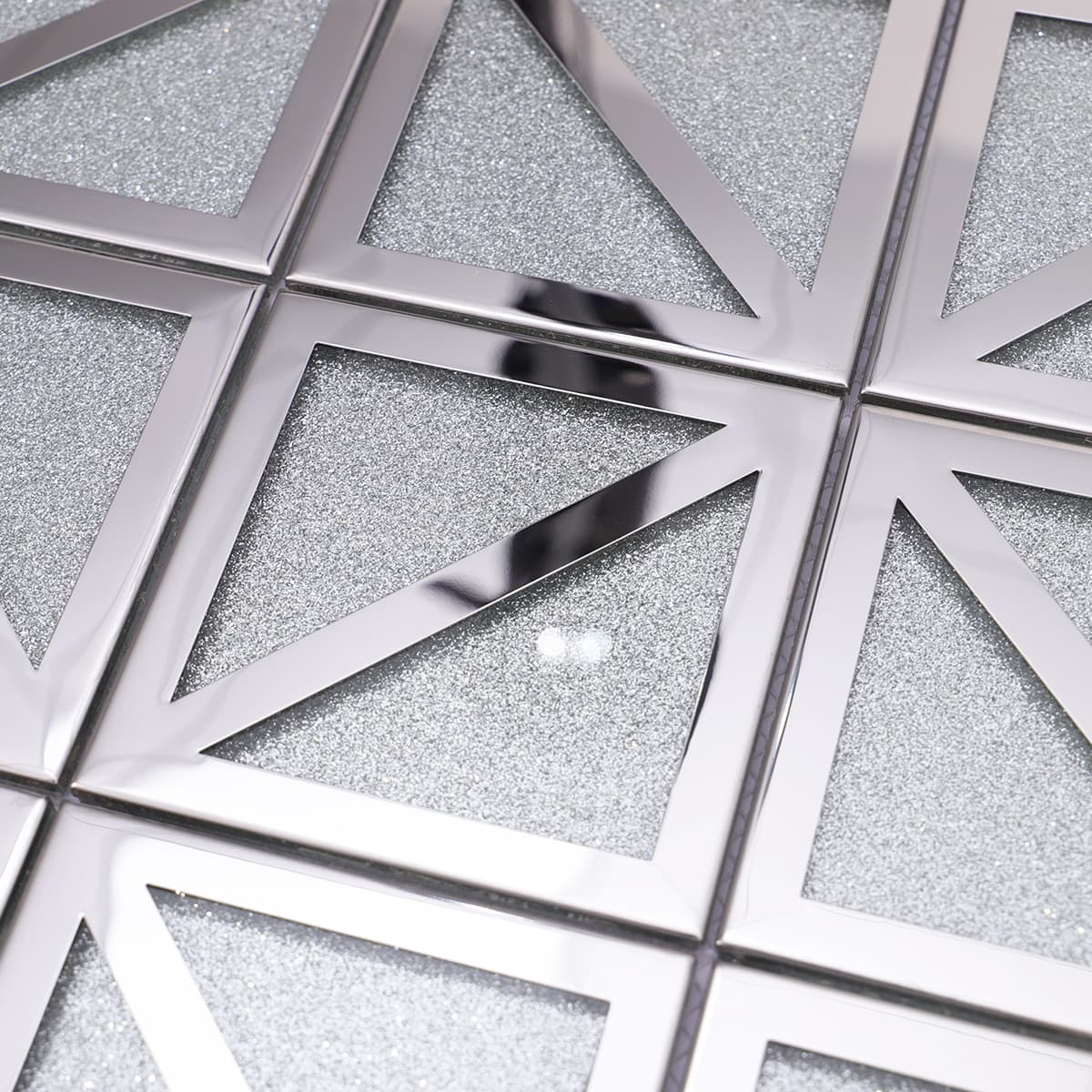 Textured view showing silver glitter glass with polished metal triangle border