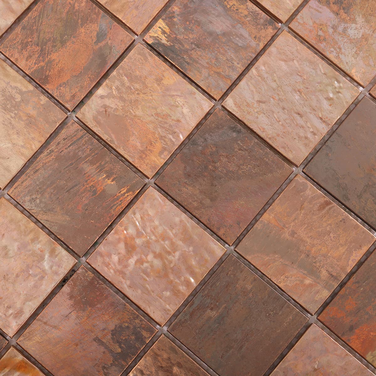 Close-up of brushed surface on antique copper mosaic tiles
