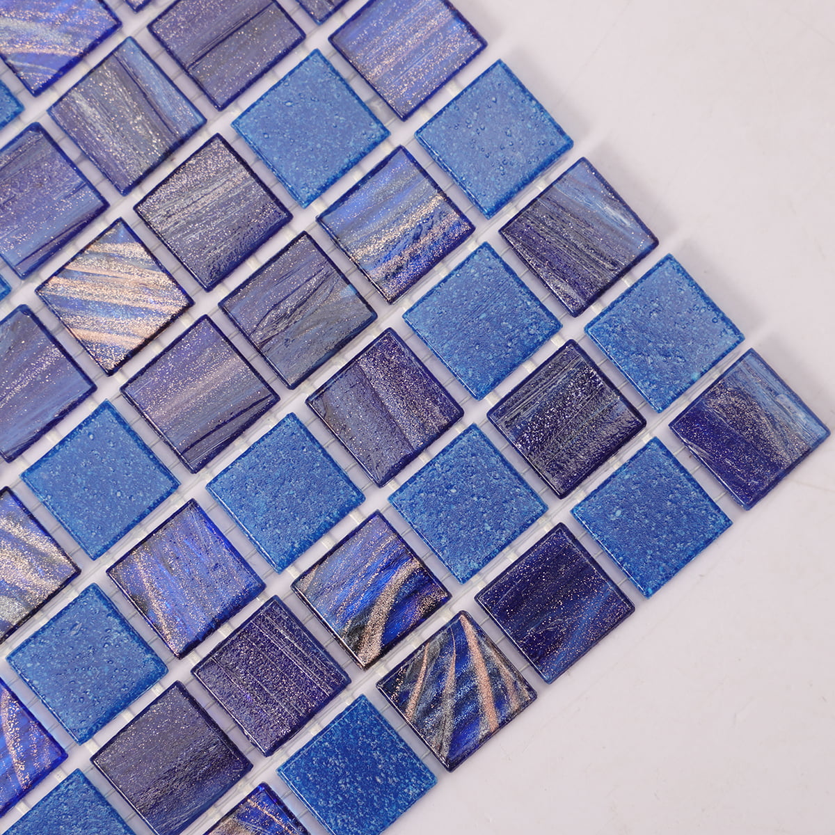 Detailed view of square blue mosaic tiles showcasing varied textures