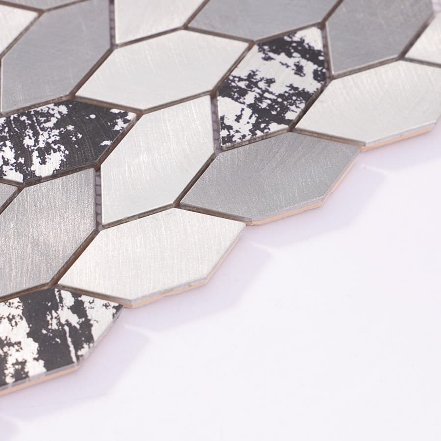 Side angle view of brushed aluminum mosaic tiles showing edge profile and layered finish.