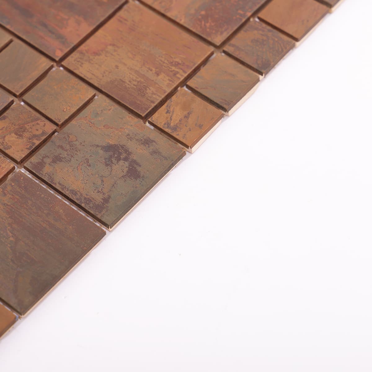 Edge of rustic copper mosaic tile with varied tile sizes