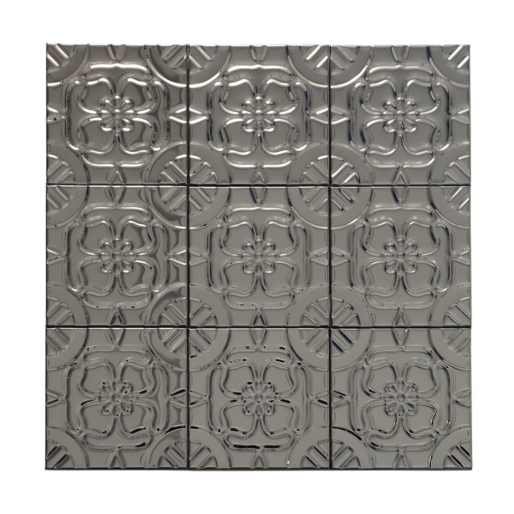 Front view of embossed black floral metal wall tile sheet on white background.