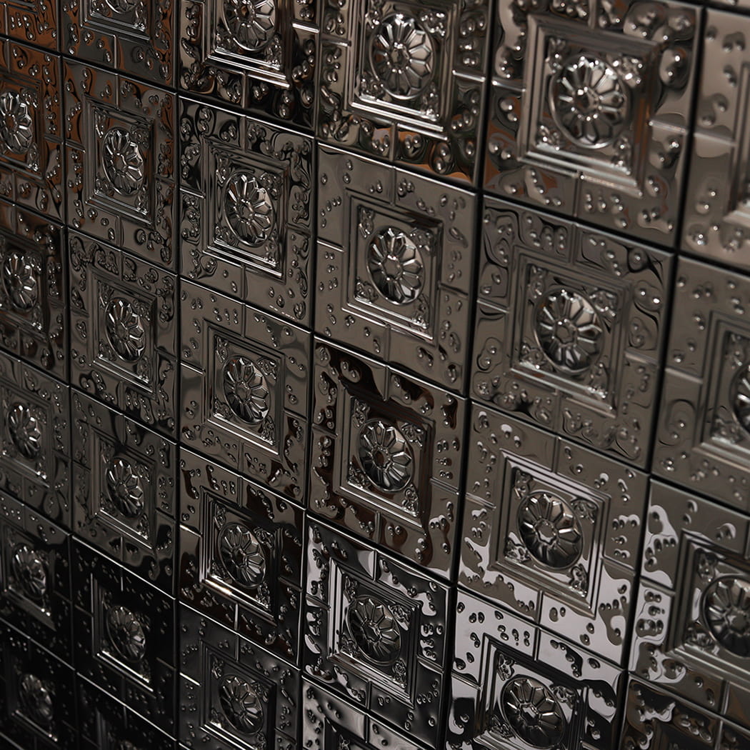 Angled perspective of embossed black metal mosaic tiles on interior wall