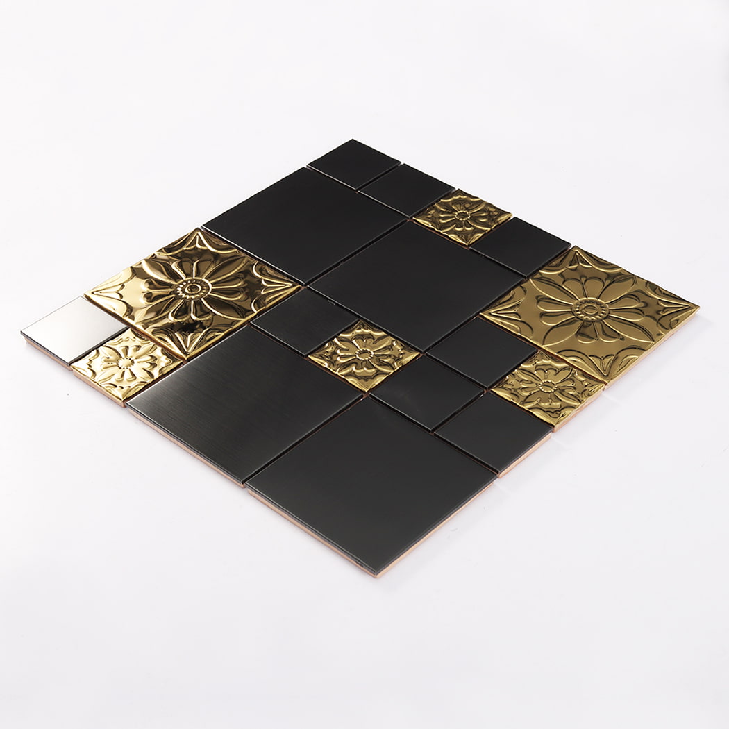 Angled view of embossed floral black stainless steel mosaic tile with gold decorative elements